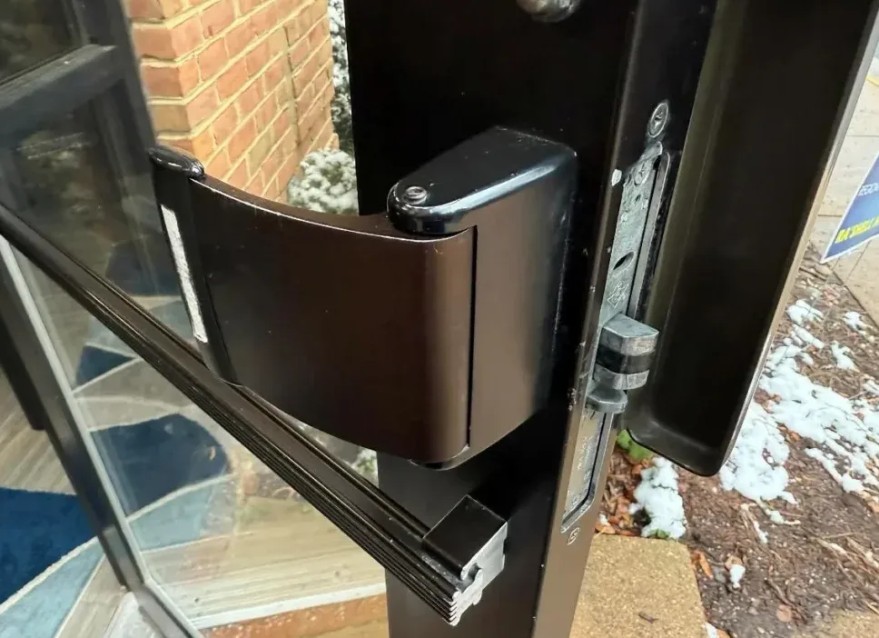 Fire-rated door with intumescent seal and self-closing hardware serviced by Triton Locksmith