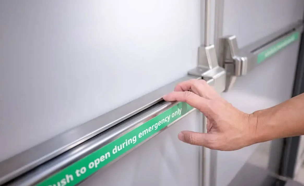 Commercial exit device push bar installation on fire-rated door by Triton Locksmith