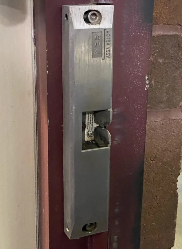 Triton Locksmith Plantation installing HES electric strike on commercial door frame in Plantation and surrounding cities