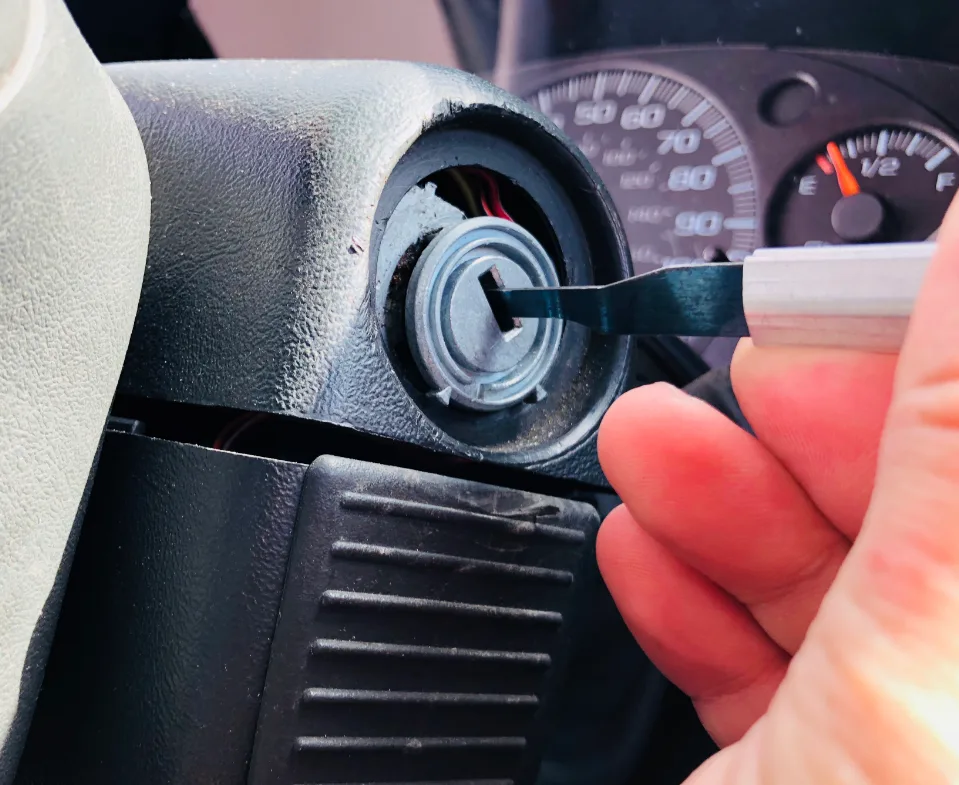 Locksmith replacing worn ignition cylinder with new unit and rekeying to match existing door key