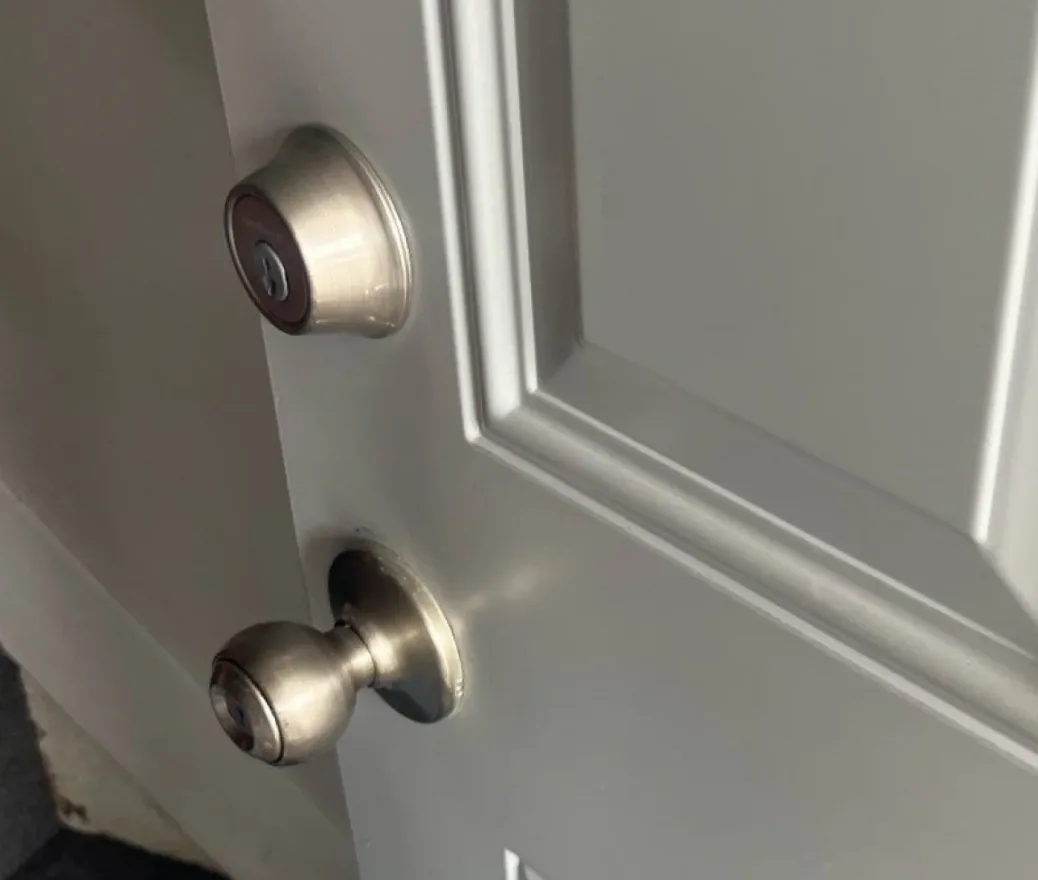 Triton Locksmith Plantation performing scheduled commercial lock maintenance on office building doors