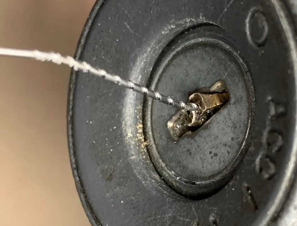 Extracting broken key piece from car ignition cylinder using professional locksmith tools